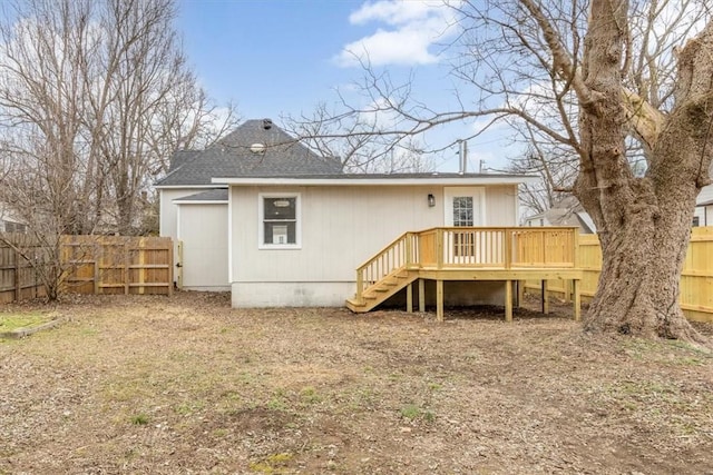 back of property featuring a wooden deck