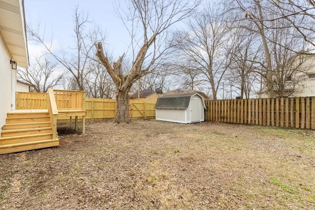 view of yard featuring a storage shed and a deck