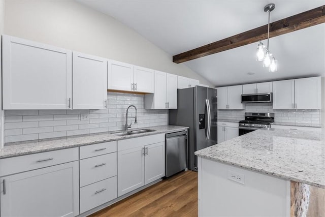 kitchen with white cabinetry, appliances with stainless steel finishes, sink, and hanging light fixtures