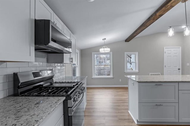 kitchen with stainless steel appliances, vaulted ceiling with beams, white cabinets, and decorative light fixtures