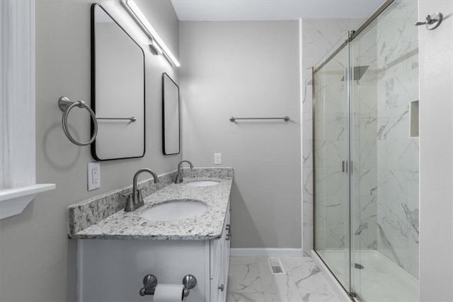 bathroom featuring vanity and a shower with shower door