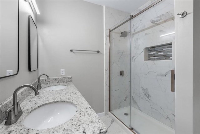 bathroom with vanity and a shower with shower door