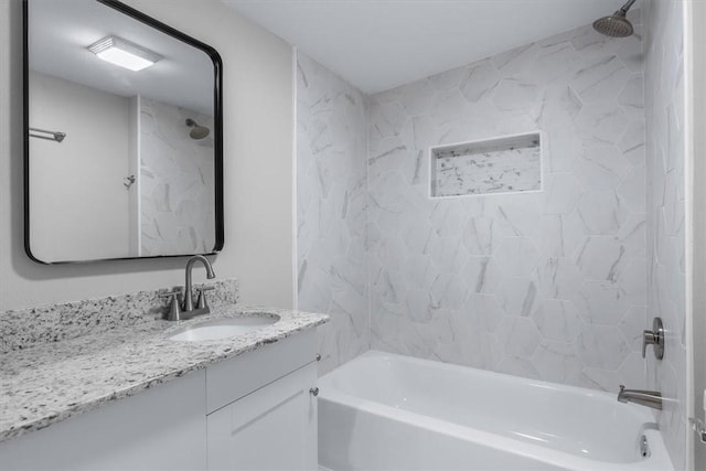 bathroom featuring vanity and tiled shower / bath combo