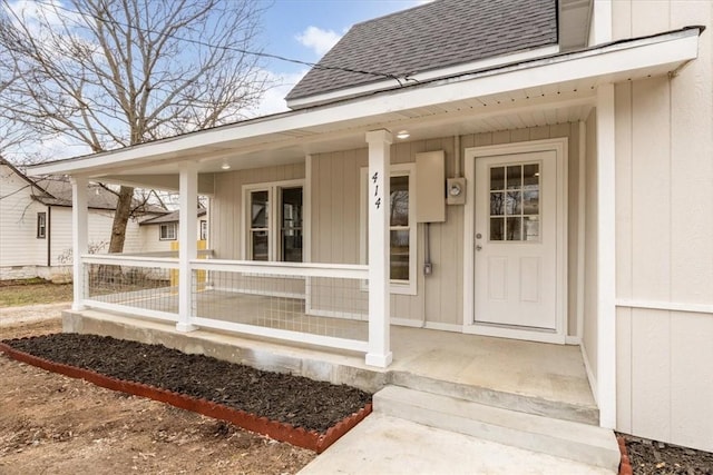 view of exterior entry featuring a porch