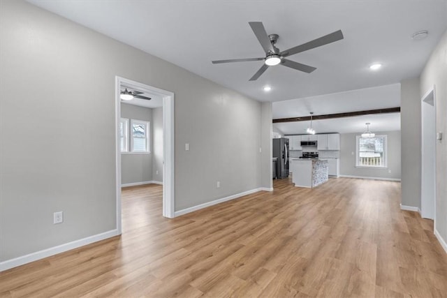 unfurnished living room featuring ceiling fan, beam ceiling, and light hardwood / wood-style flooring