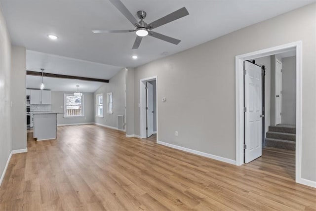 unfurnished living room with ceiling fan and light hardwood / wood-style flooring