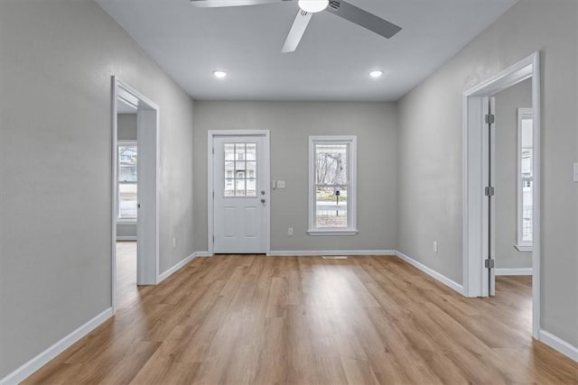 foyer with ceiling fan and light hardwood / wood-style floors