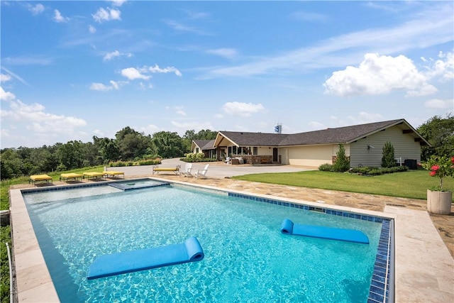 view of pool with a patio area and a lawn