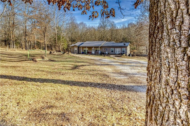 view of front of property with a front yard and solar panels