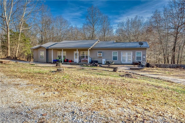 back of house with a yard and covered porch