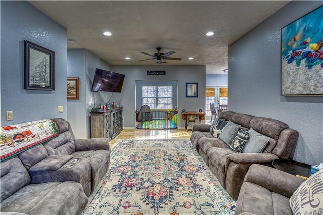 living room with wood-type flooring and ceiling fan