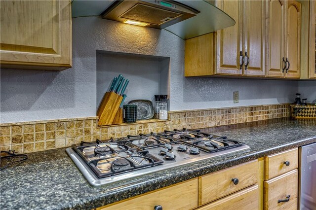 kitchen with appliances with stainless steel finishes and wall chimney exhaust hood