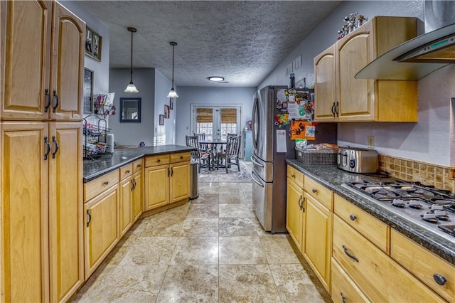 kitchen with stainless steel appliances, decorative backsplash, a textured ceiling, decorative light fixtures, and wall chimney exhaust hood