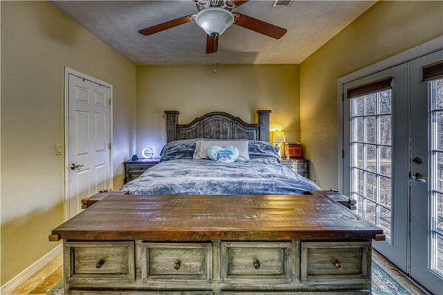 bedroom featuring ceiling fan and french doors