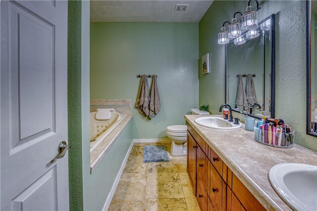 bathroom with vanity, a bathing tub, a chandelier, and toilet