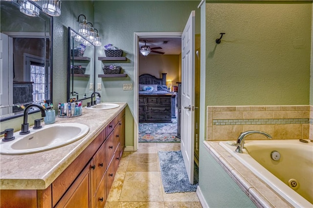 bathroom featuring vanity, ceiling fan, and a bathtub