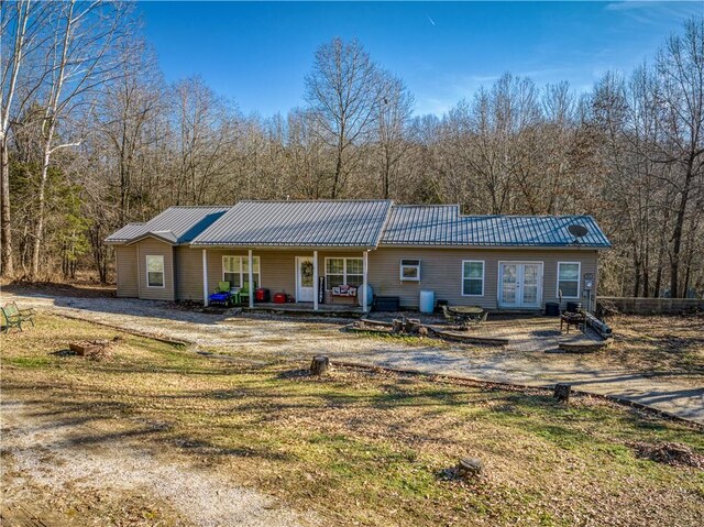 view of front of home with a front lawn and french doors