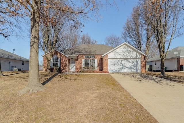 single story home featuring an attached garage, brick siding, concrete driveway, and central air condition unit