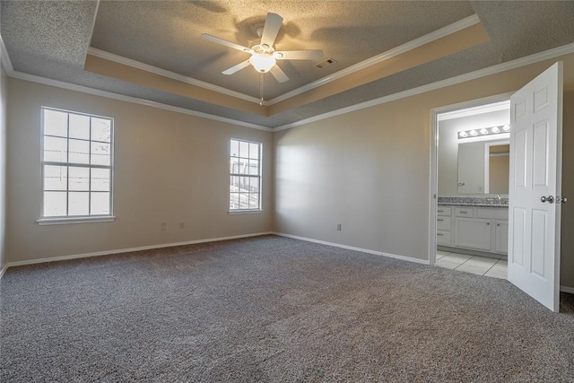 unfurnished bedroom with a raised ceiling, light carpet, multiple windows, a textured ceiling, and crown molding