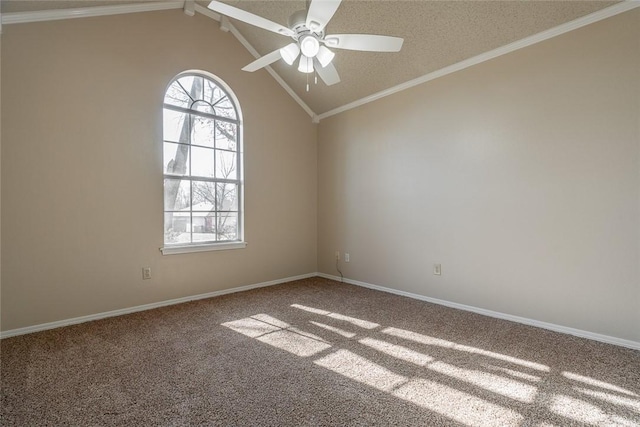 carpeted spare room with a ceiling fan, vaulted ceiling, crown molding, and baseboards