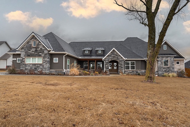 craftsman-style home with a yard