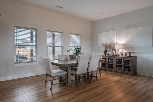 dining space with dark hardwood / wood-style floors