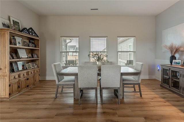 dining space with light hardwood / wood-style flooring and a wealth of natural light