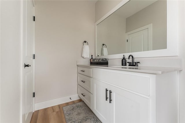 bathroom with vanity and hardwood / wood-style floors