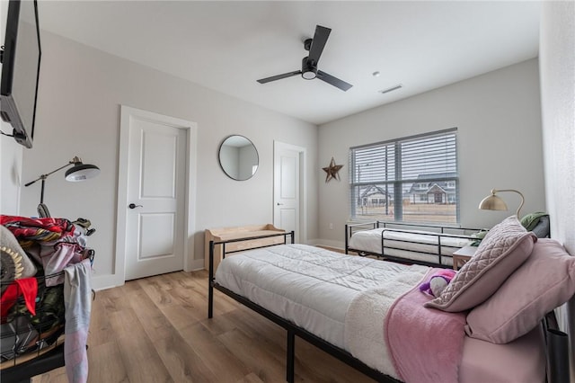 bedroom with ceiling fan and light wood-type flooring