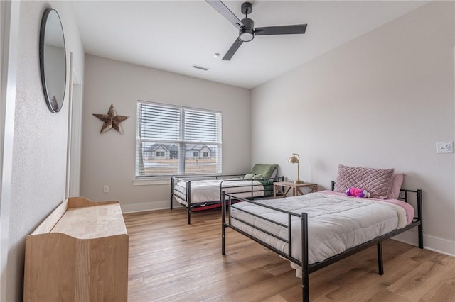 bedroom with ceiling fan and light hardwood / wood-style floors