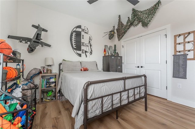 bedroom featuring hardwood / wood-style floors and a closet