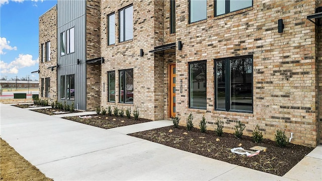 property entrance featuring brick siding