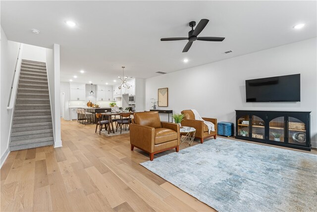 4124 W Olive St, Rogers, AR 72756 - living room with recessed lighting, visible vents, stairway, and light wood-style floors