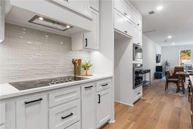 4124 W Olive St, Rogers, AR 72756 - kitchen with visible vents, light countertops, white cabinetry, and stainless steel appliances