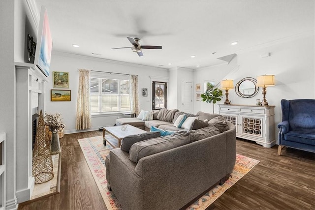 living room featuring ceiling fan, ornamental molding, and dark hardwood / wood-style flooring