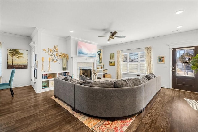 living room with crown molding, a wealth of natural light, ceiling fan, and dark hardwood / wood-style flooring