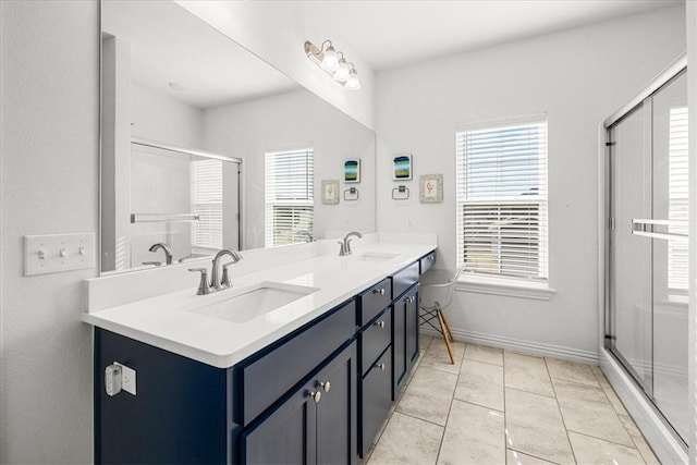 bathroom featuring tile patterned flooring, vanity, and an enclosed shower