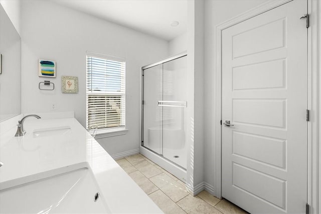 bathroom with tile patterned floors, a shower with shower door, and vanity