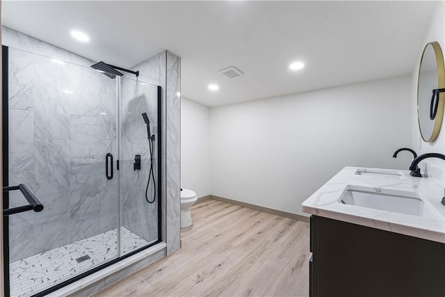 bathroom featuring an enclosed shower, hardwood / wood-style floors, vanity, and toilet