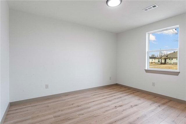 spare room with light hardwood / wood-style flooring