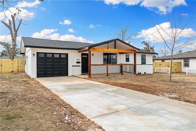 view of front of house featuring a garage and a porch