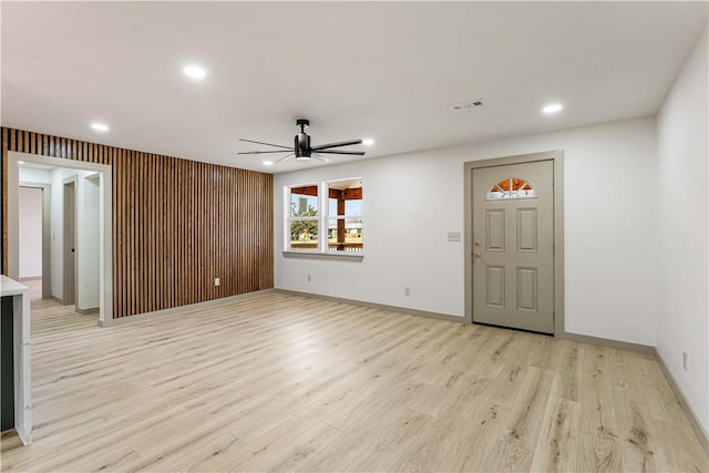 unfurnished living room with ceiling fan and light wood-type flooring