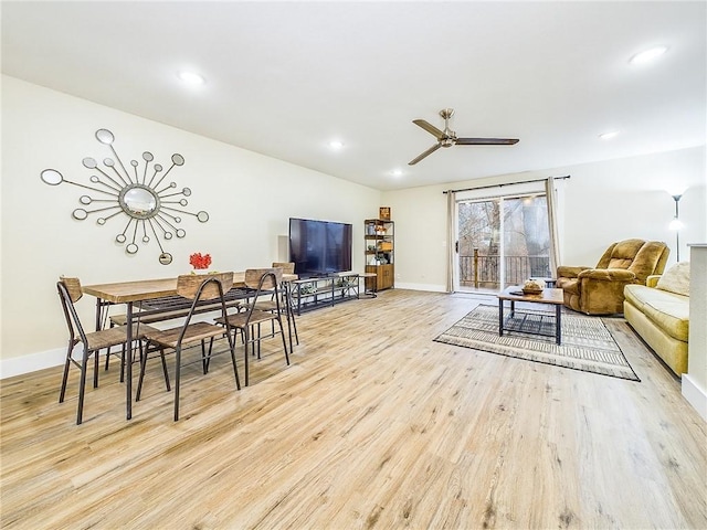 living room with ceiling fan and light hardwood / wood-style floors