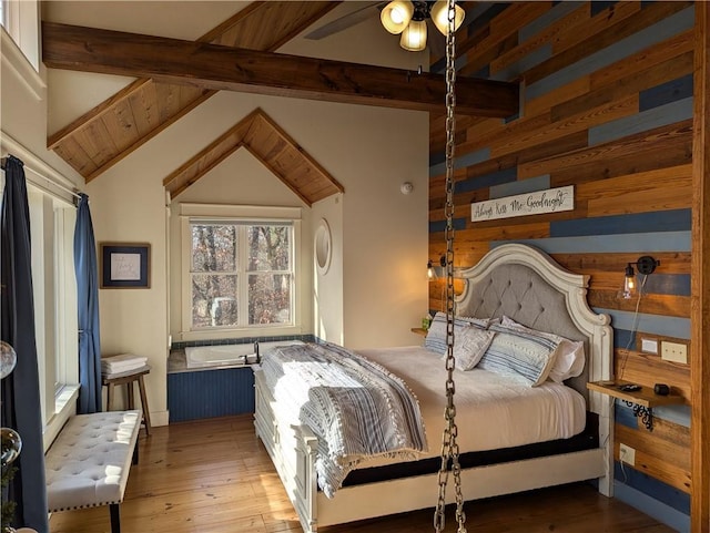 bedroom with lofted ceiling with beams, light hardwood / wood-style floors, and wooden walls