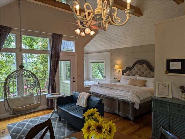 bedroom featuring lofted ceiling, dark hardwood / wood-style floors, a notable chandelier, and wood walls