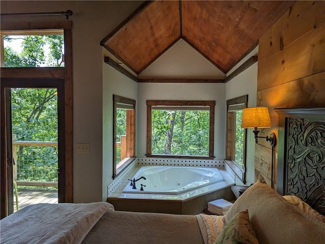 bathroom featuring wood ceiling, vaulted ceiling, and tiled tub