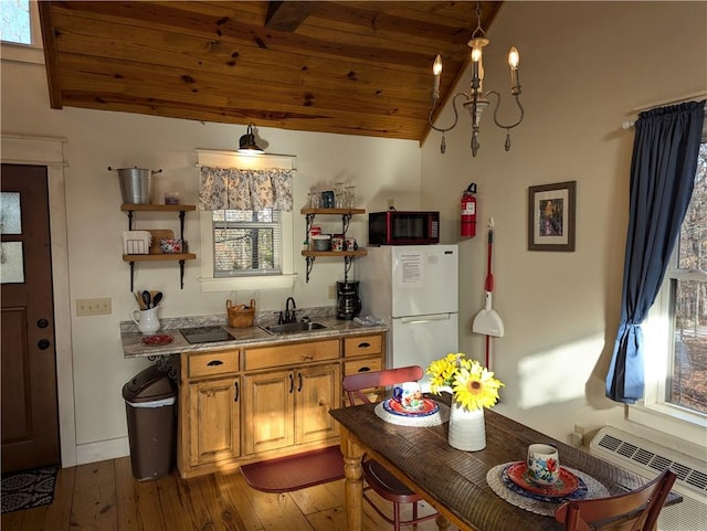 kitchen featuring vaulted ceiling, wood-type flooring, sink, white fridge, and wooden ceiling