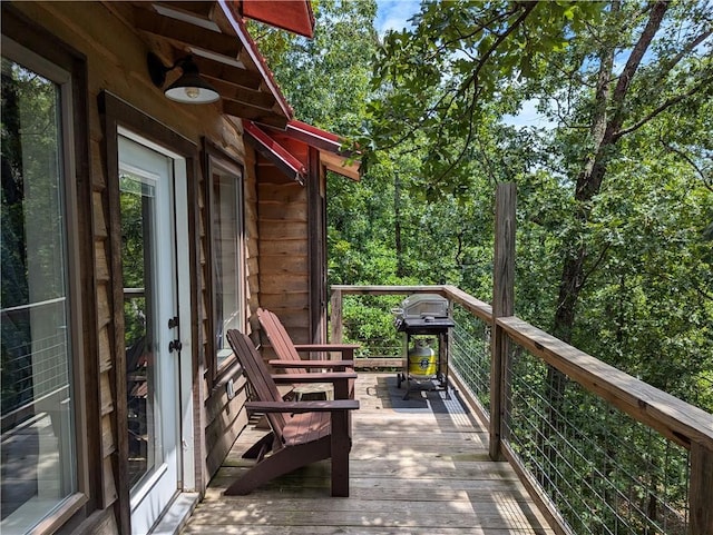 wooden balcony with grilling area and a deck