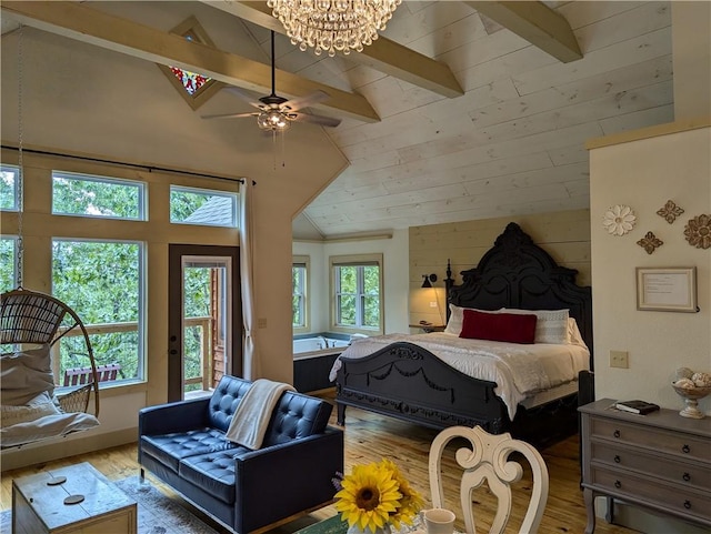 bedroom with vaulted ceiling with beams, hardwood / wood-style floors, multiple windows, and access to outside