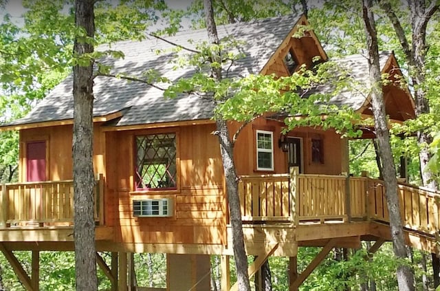 view of property exterior with a wooden deck